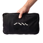 SAAL Surf Changing Poncho folded into its own mesh pocket, held in hand