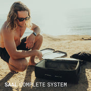 Surfer unpacking the SAAL complete surf system on the beach