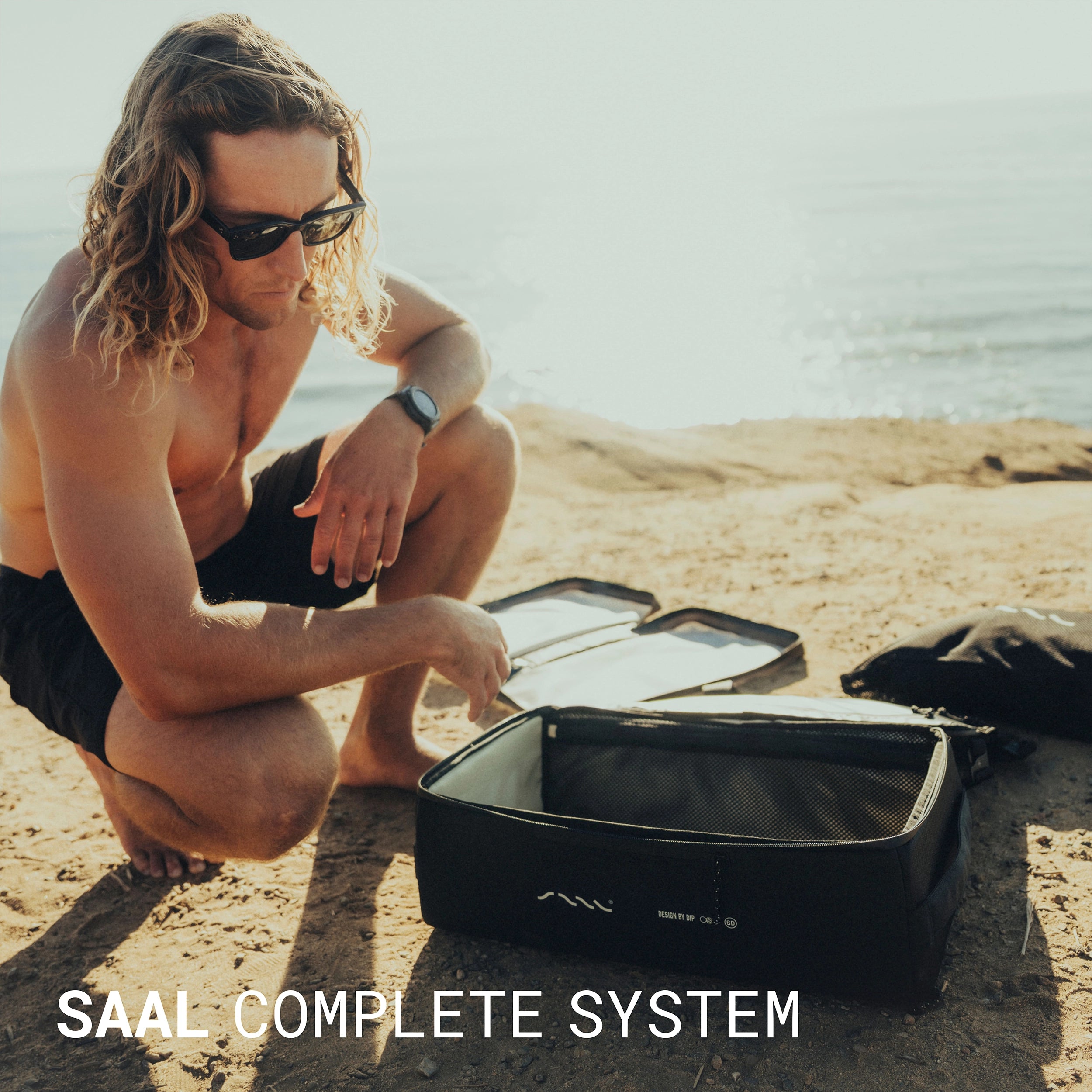 Surfer unpacking the SAAL complete surf system on the beach
