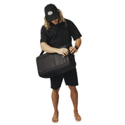Man carrying the SAAL Surfpack by its top handle