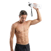 Surfer rinsing salt water off after a session with the SAAL Surf Rinse