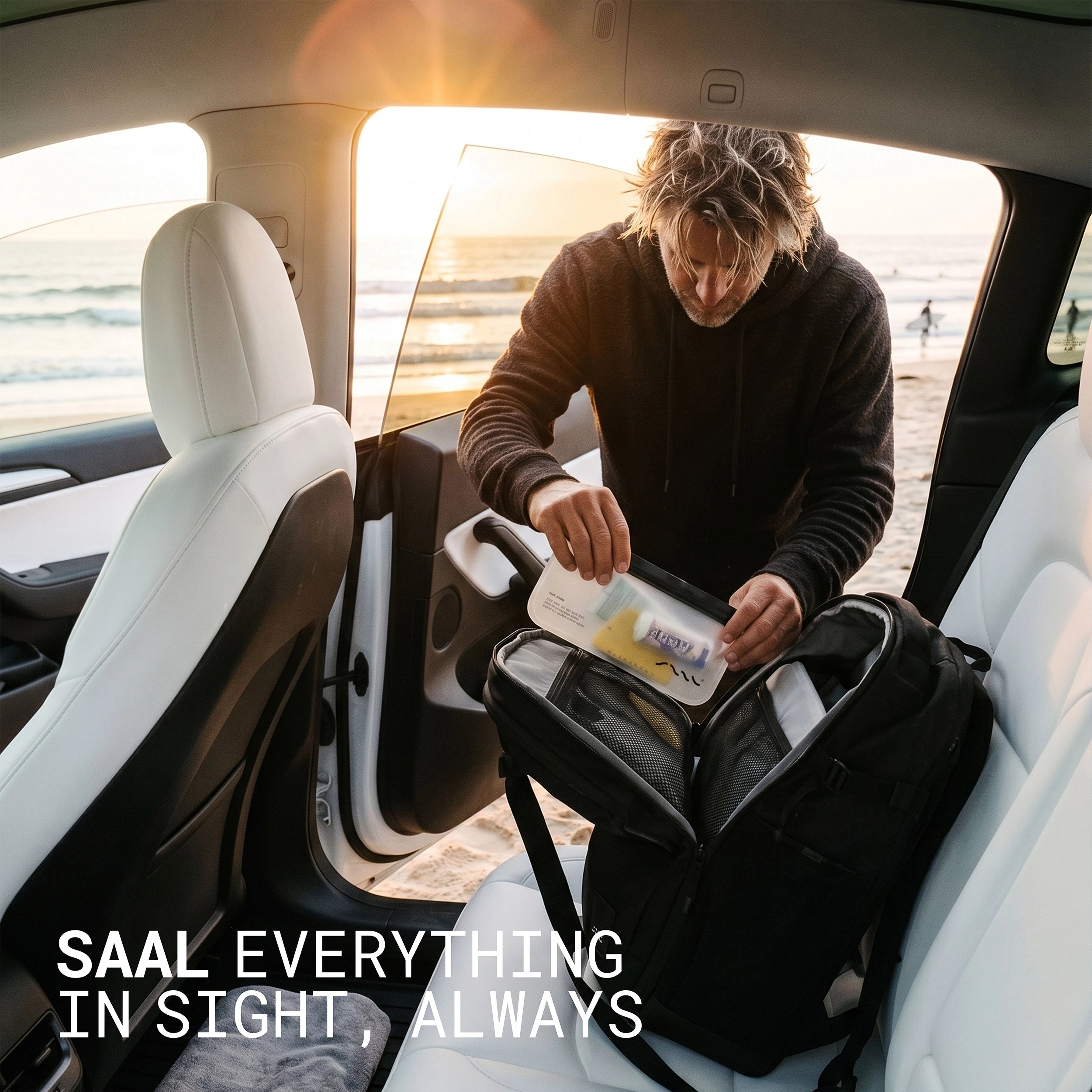 Surfer grabbing gear from the SAAL Surfpack and Surf Stash pouch in the back of a car